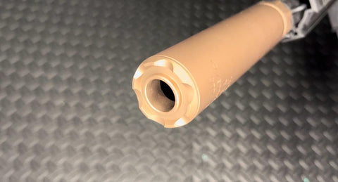 Desert tan mock silencer attachment crafted from durable metal construction